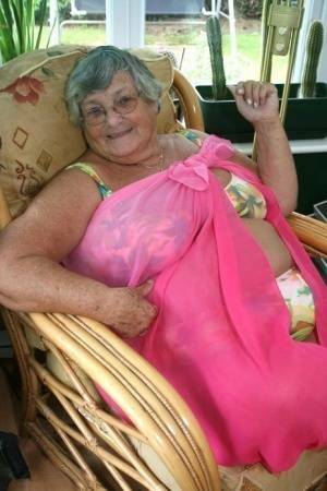 Horny old granny in glasses disrobes to reveal huge saggy tits & big BBW ass on ladyda.com