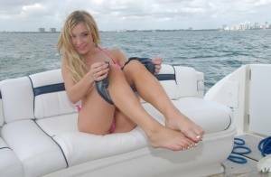 Lusty blonde Amy Brooke strips bikini and rubs pussy on the boat on ladyda.com