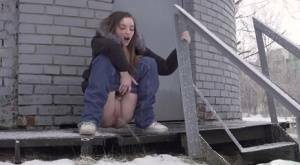 White girl pulls down her jeans to pee in the snow behind a building on ladyda.com