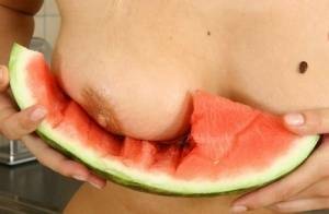Blonde vixen Flower undressing in the kitchen to eat melon with bare big tits on ladyda.com