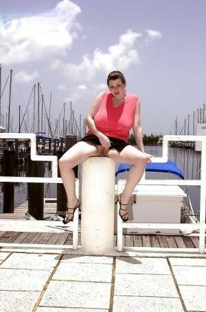 Plump pornstar Desirae flashing her huge tits and upskirt pussy on boat dock on ladyda.com