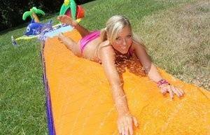 Young blonde Ally Kay ends a water fight by having sex in backyard on ladyda.com