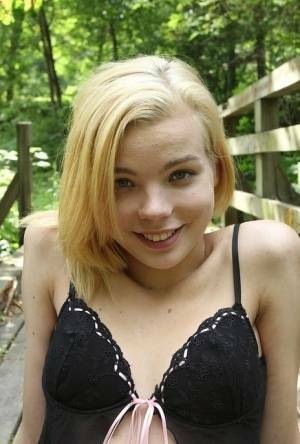 Cute teen amateur Sophia Kitten posing in nude in knee high socks in woods on ladyda.com