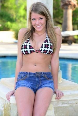 Cute teen Sophia Wood drops her shorts by the pool to toy with a vibrator on ladyda.com