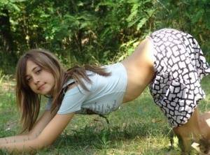 Shapely young teen in tiny t-shirt and short skirt posing outdoors on ladyda.com