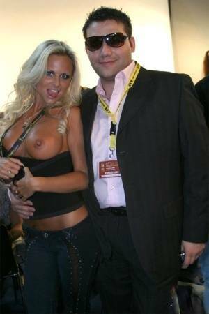 Blonde MILF Silvia Saint fully clothed posing & flaunting big tits at party on ladyda.com