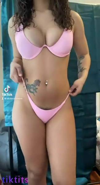 Girl in a swimsuit for TikTok sexy chic twists her tight ass on ladyda.com