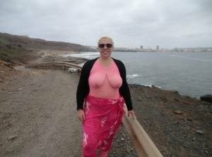 Aged lady Barby looses her big tits from a crotchless bodystocking by the sea on ladyda.com