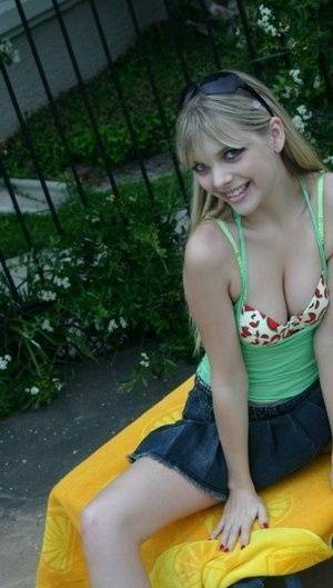 Young blonde Jana Jordan exposes her pretty bra and panties by a swimming pool - Jordan on ladyda.com