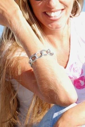 Amateur model Lori Anderson shows off her hairy arms while fully clothed on ladyda.com