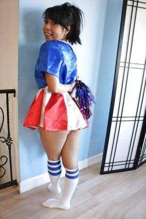 Tiny Asian cheerleader May Lee posing in cute uniform and socks on ladyda.com
