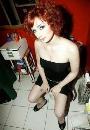 Pale redhead Violet Monroe gets naked in flat shoes while in a bathroom on ladyda.com