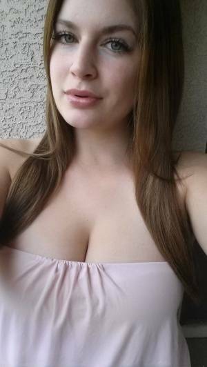 Plump amateur Danielle takes topless and clothed selfies around the house on ladyda.com