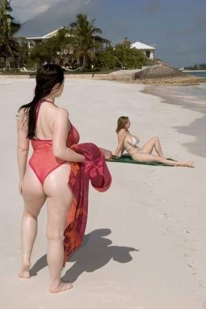 Plump female Christy Mark and her big boobed friend have lesbian sex on beach on ladyda.com
