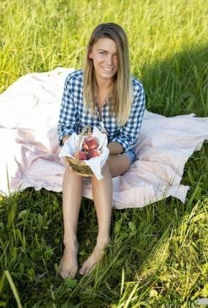 Nice teen Paulina gets completely naked on a blanket in a field on ladyda.com
