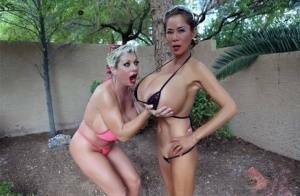 Big titted older women Claudia Marie and Minka kiss outdoors in skimpy bikinis on ladyda.com