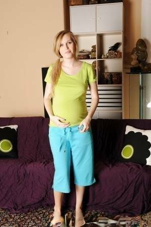 Smiley pregnant amateur with puffy nipples and hairy gash getting naked on ladyda.com