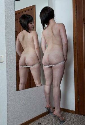 White teen with a full bush admires herself in mirror while disrobing on ladyda.com