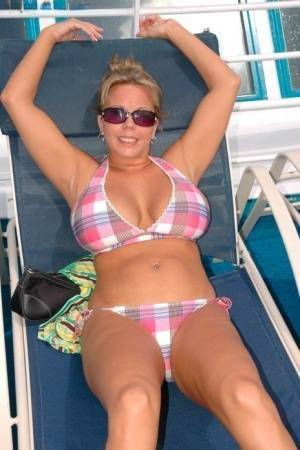 Hugely busty Amber Lynn Bach doffs her bikini to spread her legs wide nude on ladyda.com