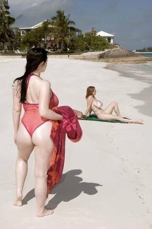 Fervent lesbians stripping nude and playing with dildos on the beach on ladyda.com