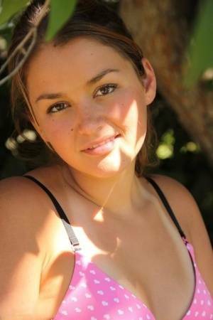 Petite amateur Allie Haze shows her tan lined body in the shade of a tree on ladyda.com