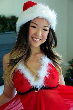 Cute Asian teen Lulu Chu wears Xmas lingerie during sex on a bed on ladyda.com