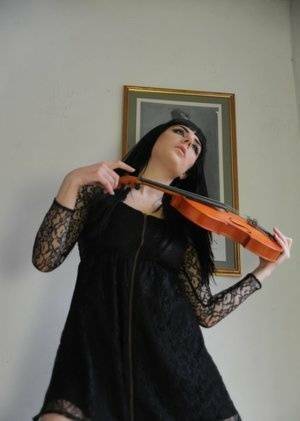 Dark haired violin player Sam Bentley strikes great poses while getting naked on ladyda.com