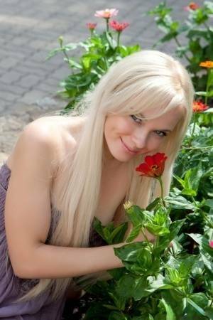 Beautiful Feeona flashes a nude upskirt and gets on her knees in the park on ladyda.com