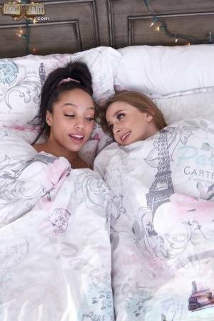 Interracial lesbians lick assholes and pussies on a bed in sport socks on ladyda.com