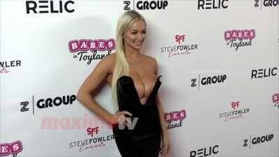 Lindsey Pelas' tits are so big that she have to push them back on ladyda.com