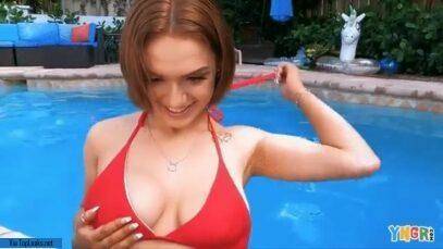 Gracie Gates coyly undoes her top in the pool on ladyda.com