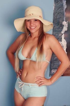 Solo girl Dawson Miller takes off her bikini while wearing a floppy sun hat on ladyda.com