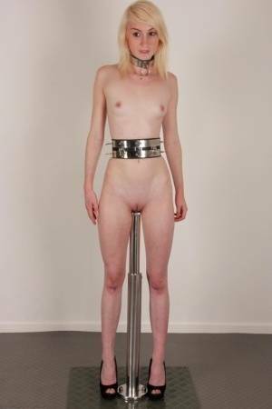 Skinny blonde teen Noa sports a collar while impaled on a dildo post on ladyda.com