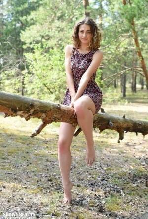 Nice young girl Ari gets completely naked while in a forested area on ladyda.com