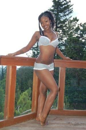 Black girl Amber uncups her big tits while getting in an outdoor hot tub on ladyda.com
